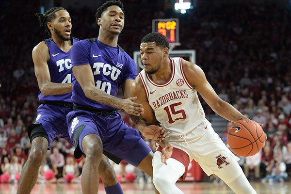 Arkansas guard Mason Jones (15) drives to the lane Saturday, Jan. 25, 2020, as TCU forward Diante Smith (10) defends during the second half of the Razorbacks' 78-67 win in Bud Walton Arena. 