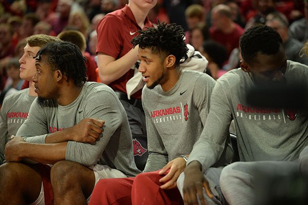 Arkansas guard Isaiah Joe (center) watches from the bench Saturday, Jan. 25, 2020, during the second half of the Razorbacks' 78-67 win over TCU in Bud Walton Arena. Joe was held out of the game because of an injury, according to university sports information officials. 