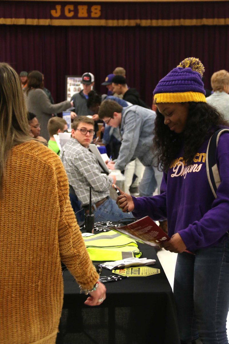 A student clicks a pen to fill out a form for a company Jan. 23 during Junction City High School's first day-time career fair. The fair featured over 30 vendors.