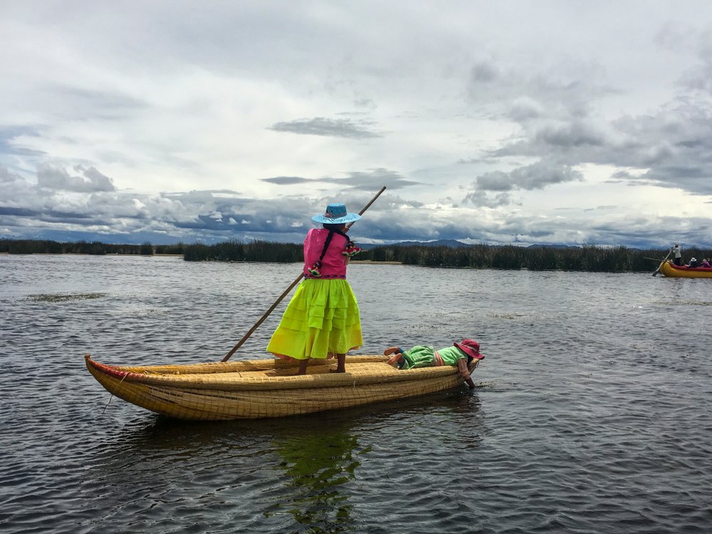 A young woman poles through the shallow waters of Lake Titicaca. Although the lake is nearly 1,000 feet deep, the Uros live close to the shoreline where the reeds grow and the lake is no more than 10 feet deep.
(TNS/Thomas Curwen)