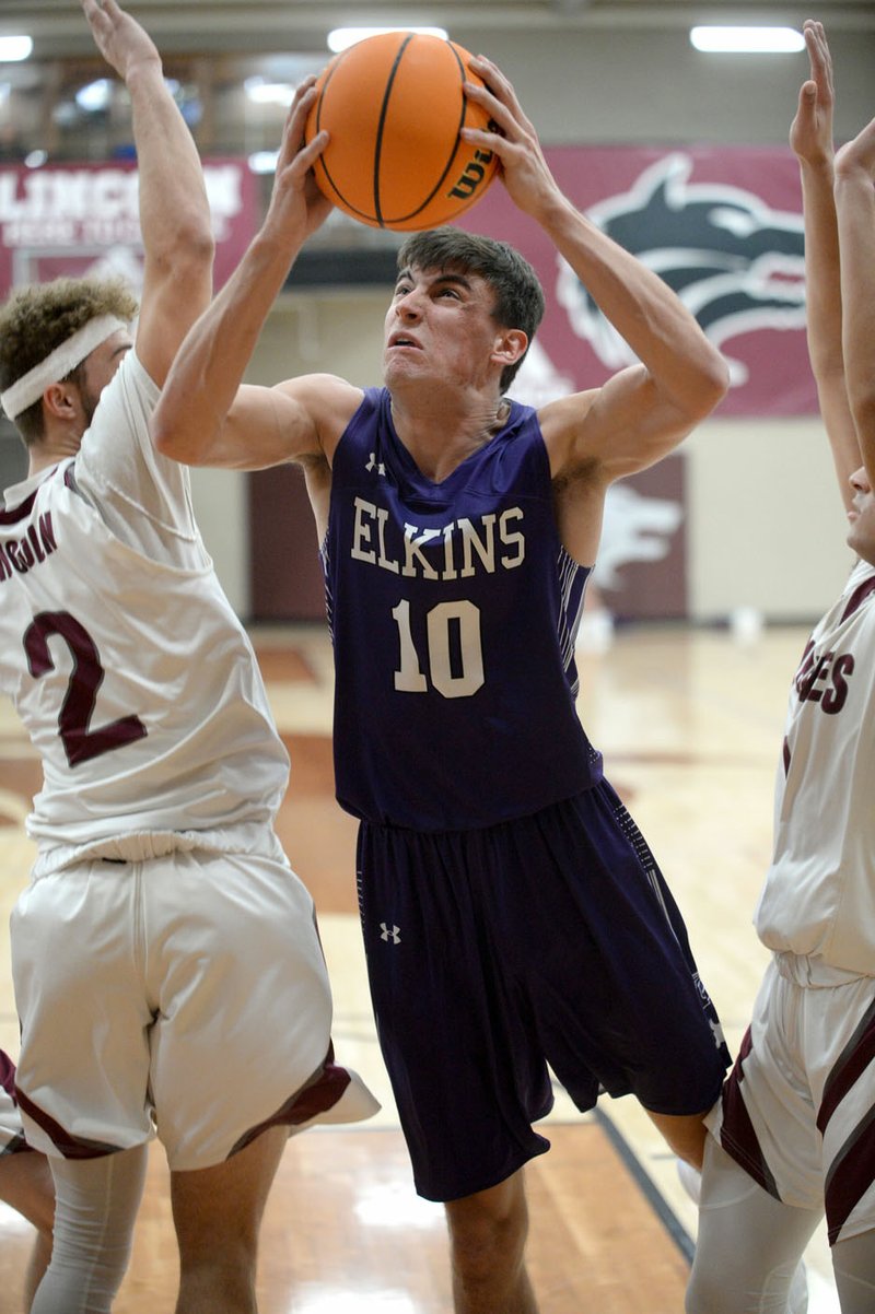 Elkins senior Paxton Barnett (center) makes a move to the basket Tuesday, Jan. 14, 2020, during play against Lincoln in Lincoln. Barnett is averaging 17.3 points and 8.2 rebounds per game for the Elks, who are in the thick of the 3A-1 West Conference race. Check out nwaonline.com/200127Daily for today's photo gallery. (NWA Democrat-Gazette/Andy Shupe)