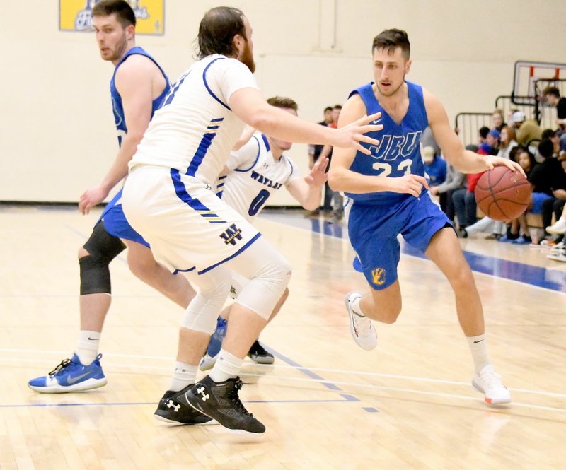 Photo courtesy of Wayland Baptist Sports Information John Brown junior guard Rokas Grabliauskas drives the lane Thursday against Wayland Baptist in the Golden Eagles' 64-56 victory in Plainview, Texas.
