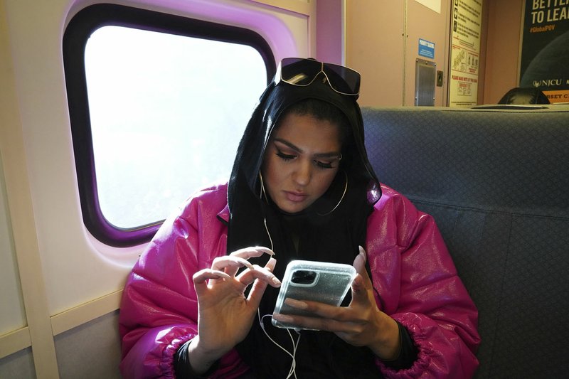Amani Al-Khatahtbeh, founder of MuslimGirl.com, sits for an interview inside her family's video game and electronic store business in Somerville, N.J. Al-Khatahtbeh started the website as a way to defy Muslim stereotypes after 9/11. A decade later, Al-Khatahtbeh has built it into an online magazine with a global audience. (AP/Emily Leshner)