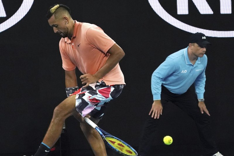 Australia's Nick Kyrgios plays the ball back between his legs to Russia's Karen Khachanov Saturday during their third round singles match at the Australian Open in Melbourne, Australia. - Photo by Lee Jin-man of The Associated Press