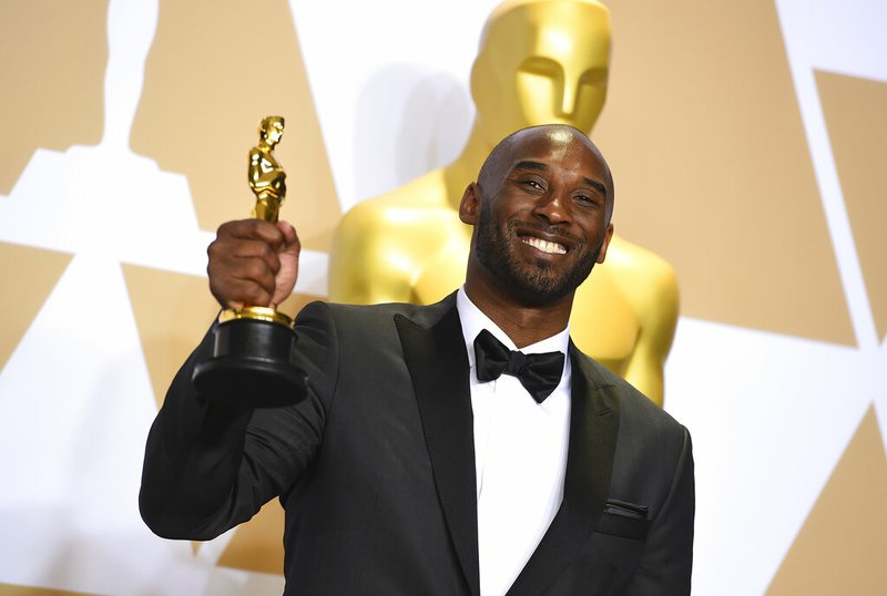 FILE - This March 4, 2018 file photo shows Kobe Bryant, winner of the award for best animated short for "Dear Basketball", at the Oscars in Los Angeles. Bryant, a five-time NBA champion and a two-time Olympic gold medalist, died in a helicopter crash in California on Sunday, Jan. 26, 2020. He was 41. (Photo by Jordan Strauss/Invision/AP, File)