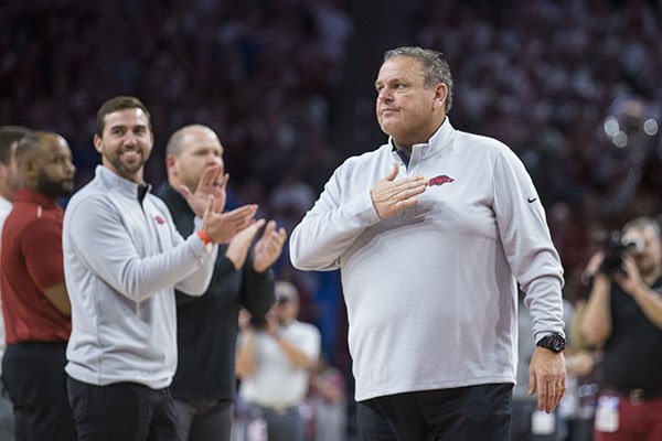 Arkansas football coach Sam Pittman (right) is shown with his assistant coaching staff during the Razorbacks' basketball game against Kentucky on Saturday, Jan. 18, 2020, at Bud Walton Arena in Fayetteville. At left and facing is offensive coordinator Kendal Briles. 