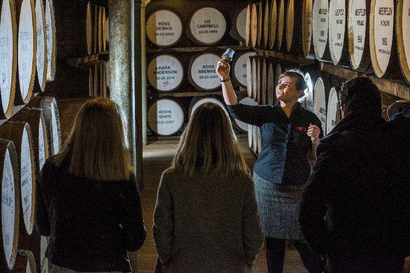 Visitors are guided in 2018 during a cellar tour of the Dewar’s Distillery in Aberfeldy in the Scottish Highlands where Scotch whiskey has been produced since 1898. 
(AP/Bacardi Limited)