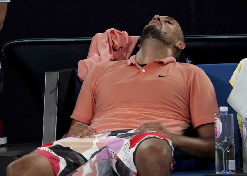 Australia’s Nick Kyrgios rests in his chair after defeating Russia’s Karen Khachanov in five sets in their third round singles match at the Australian Open on Saturday.
(AP/Lee Jin-man)