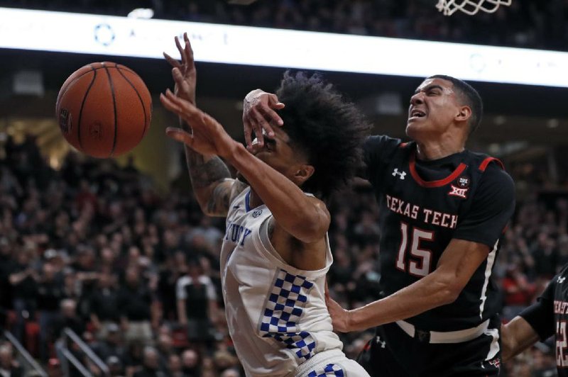 Kentucky’s Nick Richards (left) loses control of the ball as he is fouled by Texas Tech’s Kevin McCullar during the second half of the No. 15 Wildcats’ 76-74 overtime victory over the No. 18 Red Raiders on Saturday in Lubbock, Texas.
(AP/Brad Tollefson)