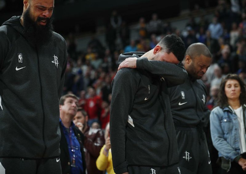 Houston Rockets guard Austin Rivers (left) and forward P.J. Tucker react during a tribute to Kobe Bryant before Sunday’s game against the Denver Nuggets in Denver.
