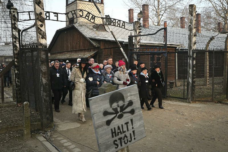 Polish President Andrzej Duda walks with survivors through the gates of Auschwitz on Monday, the 75th anniversary of the death camp’s liberation.  
