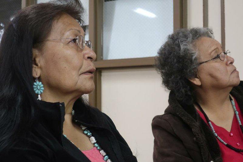 Margaret Bitsue (left) and her sister Rita Bilagody listen to presentations at a forum on missing indigenous men earlier this month in Tuba City, Ariz.  