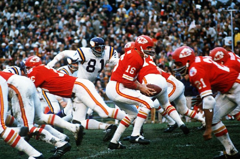 Kansas City Chiefs quarterback Len Dawson (16) turns around to hand the ball off to running back Mike Garrett (21) during Super Bowl IV on Jan. 11, 1970, in New Orleans. As Kansas City pre- pares to play San Francisco on Sunday in Super Bowl LIV, many members of the 1970 team did not live to see the the Chiefs return to the championship game, and many others are in failing health.