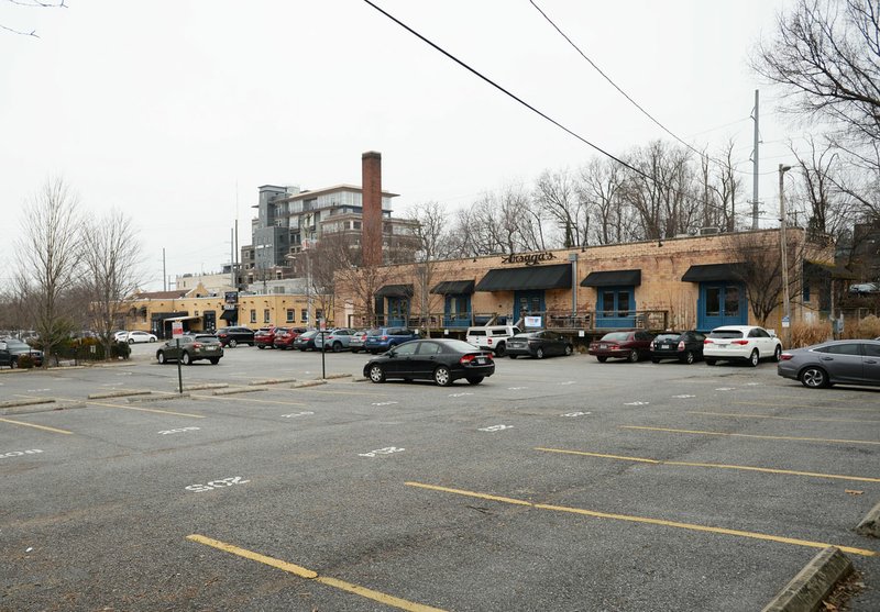 Vehicles are parked Tuesday in a parking lot near Arsaga's at the Depot in Fayetteville. The city and private landowners of the lot have been negotiating a deal on the location of a new parking deck downtown to replace the 290 spaces lost once the Walton Arts Center parking lot becomes the civic green space of the cultural arts corridor. Visit nwaonline.com/200129Daily/ for today's photo gallery. (NWA Democrat-Gazette/Andy Shupe)