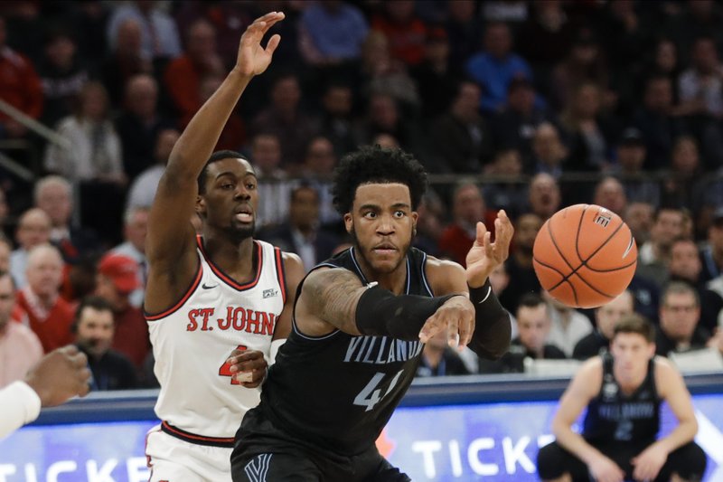 Villanova's Saddiq Bey (41) passes the ball away from St. John's Greg Williams Jr. (4) during the first half of an NCAA college basketball game Tuesday, Jan. 28, 2020, in New York. (AP Photo/Frank Franklin II)