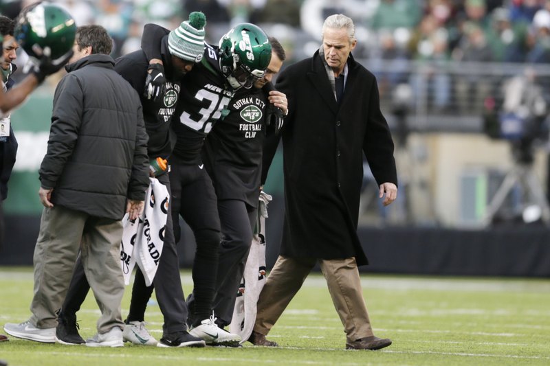 New York Jets cornerback Kyron Brown (35) is helped off the field after being injured during the second half of a Dec. 8, 2018 NFL game against the Miami Dolphins in East Rutherford, N.J. The New York Jets finished the season with a league-high 20 players on injured reserve and had so many other injuries the organization is studying every step from practice to recovery down to how they care for injuries to stay healthier in the future. Jets general manager Joe Douglas hopes 2019 was a "bit of anomaly." - Photo by Adam Hunger of The Associated Press