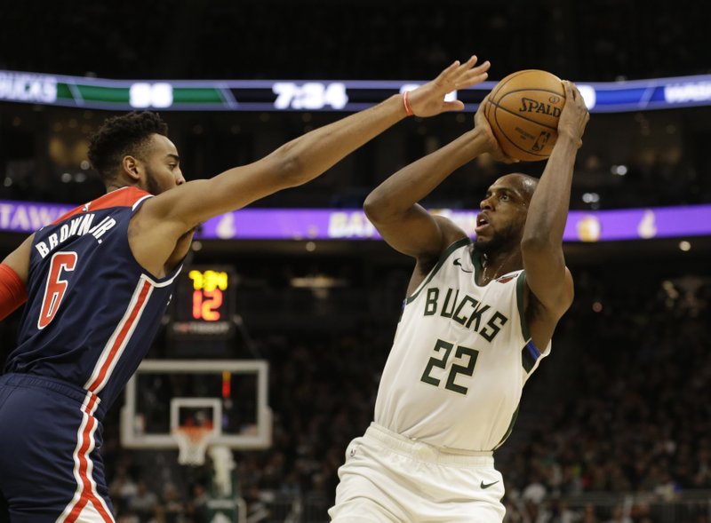 Milwaukee Bucks' Khris Middleton puts up a shot against Washington Wizards' Troy Brown Jr. during during the second half of Tuesday's game in Milwaukee. - Photo by Jeffrey Phelps of The Associated Press