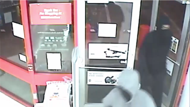 In a screenshot of surveillance video provided by North Little Rock police, two males enter the AutoZone store at 400 Camp Robinson Road before an armed robbery.