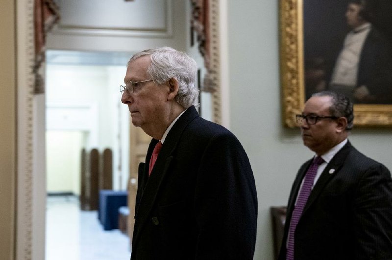 Senate Majority Leader Mitch McConnell leaves the Capitol on Tuesday after meeting privately with fellow GOP senators following the conclusion of the day’s impeachment trial proceedings. More photos at arkansasonline.com/129impeachment/.
(The New York Times/Anna Moneymaker) 