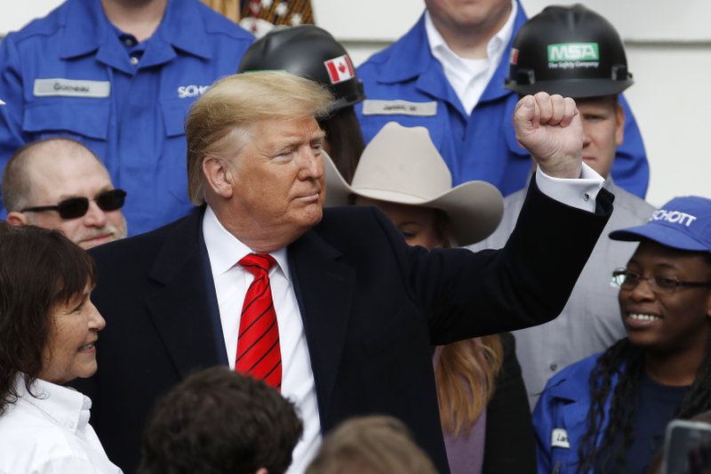 President Donald Trump pumps his fist after signing a new North American trade agreement with Canada and Mexico, during an event at the White House, Wednesday, Jan. 29, 2020, in Washington. Trump's impeachment trial is shifting to questions from senators, a pivotal juncture as Republicans lack the votes to block witnesses and face a potential setback in their hope of ending the trial with a quick acquittal. (AP Photo/Alex Brandon)