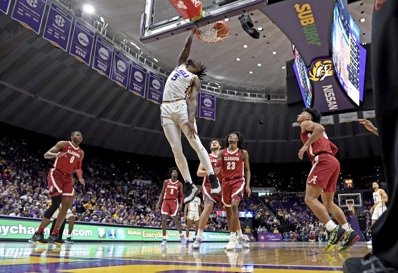 LSU forward Emmitt Williams (5) dunks the ball as Alabama defenders watch in the first half of an NCAA college basketball game, Wednesday, Jan. 29, 2020, in Baton Rouge, La. (AP Photo/Bill Feig)