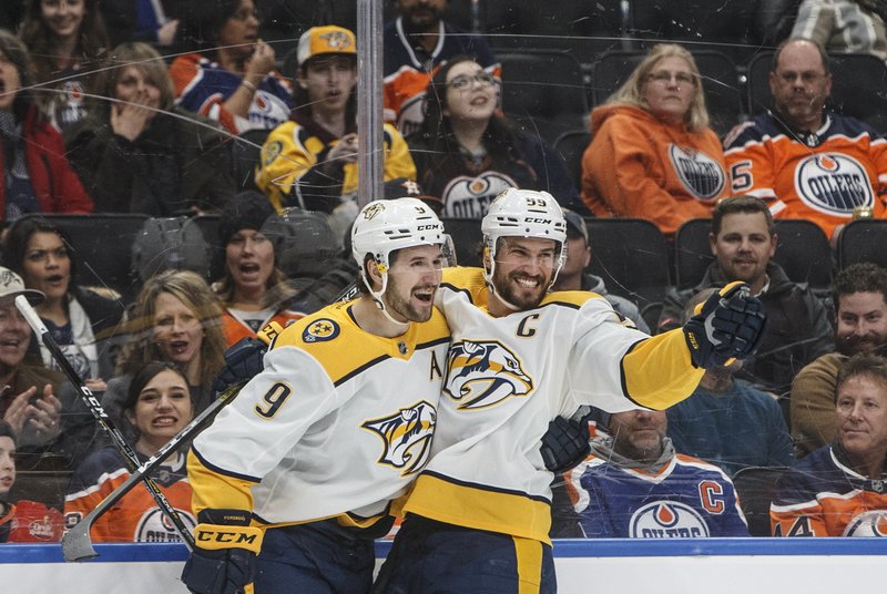 Nashville Predators' Filip Forsberg (9) and Roman Josi (59) celebrate a goal during the first period of Tuesday's game against the Edmonton Oilers in Edmonton, Alberta. - Photo by Jason Franson/The Canadian Press via The Associated Press