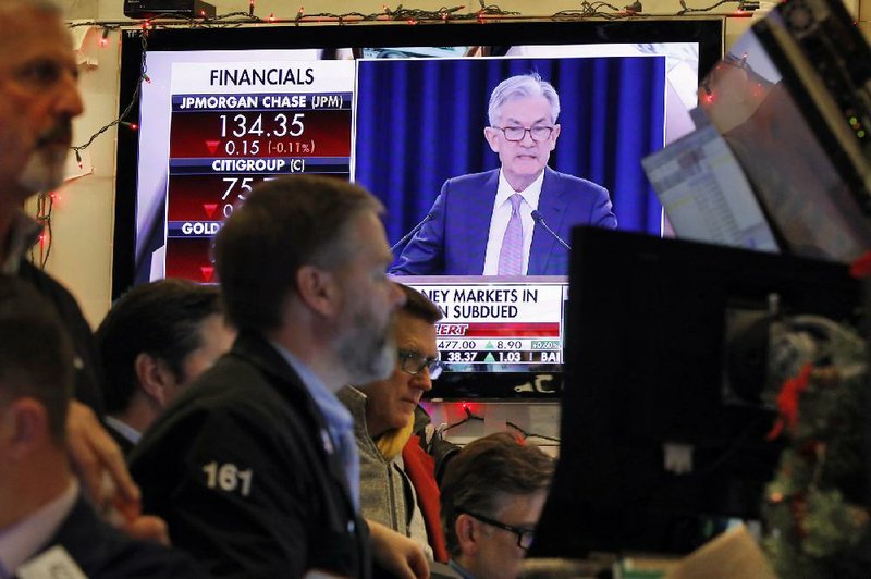 A television screen on the floor of the New York Stock Exchange shows Federal Reserve Board Chairman Jerome Powell speaking last month. The Fed Board on Thursday approved a proposal to ease restrictions on Wall Street banks’ investing in venture capital funds.
(AP/Richard Drew)