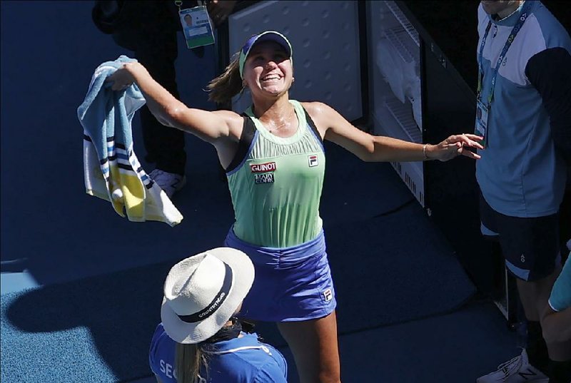 American Sofia Kenin throws her towel into the crowd after defeating Australia’s Ashleigh Barty in their semifinal match today at the Australian Open.
(AP/Andy Wong)