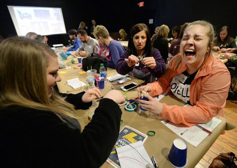 Cassandra Satterfield (from right) laughs Thursday as she and fellow Lowell Elementary School teachers Sarah Henry and Jordan Shannon build a robot during the Arkansas Maker Summit in downtown Springdale. The event featured lectures, panels and periods for construction for members of the maker community in several downtown venues. Go to nwaonline.com/200131Daily/ for today's photo gallery. (NWA Democrat-Gazette/Andy Shupe)