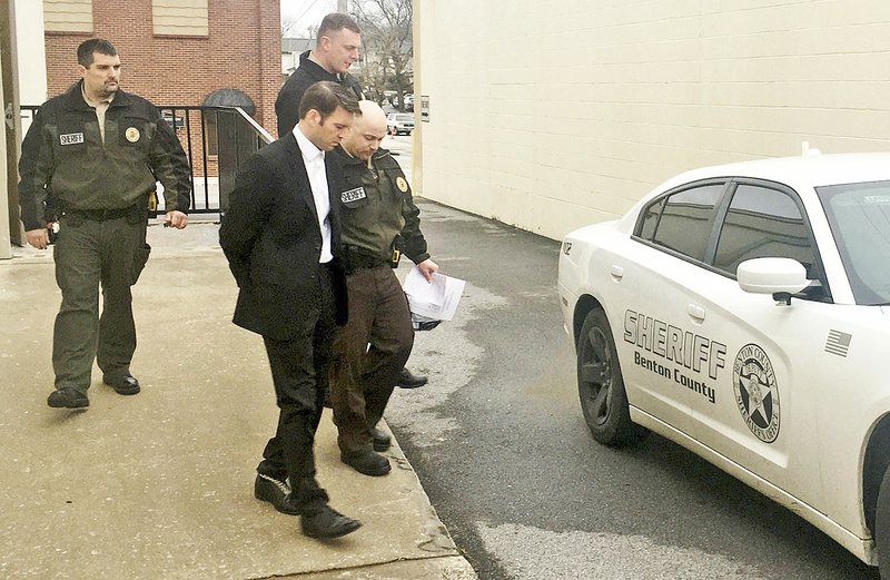 Tristan Nathaniel Tiarks is escorted Thursday to a Benton County Sheriff's Office vehicle after his trial in Bentonville. (NWA Democrat-Gazette/Tracy Neal)
