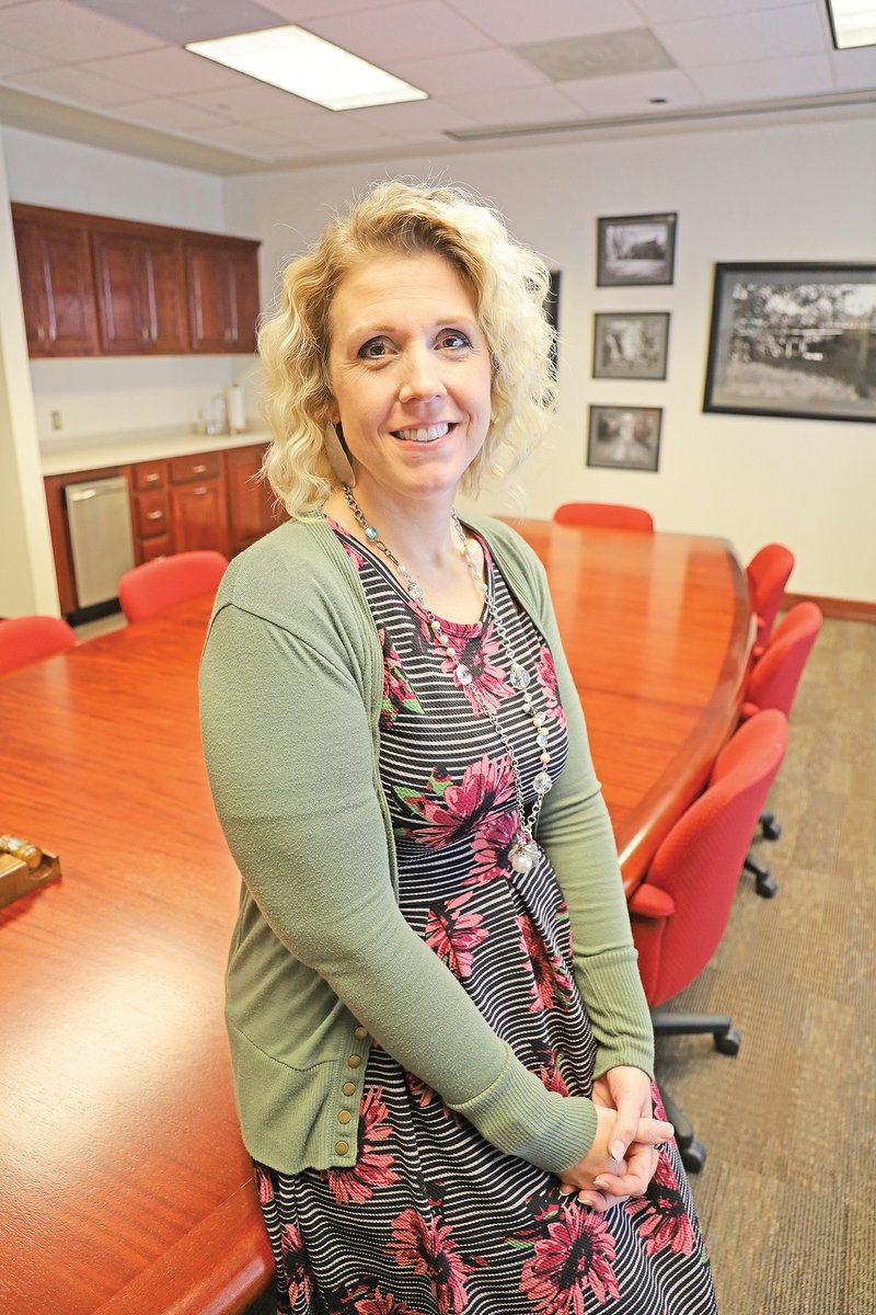 Brandy Harris leans against a conference table at First Arkansas Bank & Trust in Jacksonville, where she is a regulatory lending auditor. Harris said the company stresses community involvement, which is what prompted her to join the Jacksonville Sertoma Club about 18 months ago. She was recently named the club’s Sertoman of the Year. 