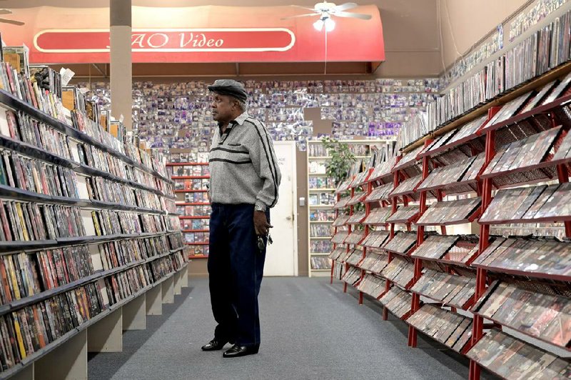Charles Finley, 70, of Little Rock, checks out the selection of videos Friday at downtown’s R.A.O. Video.