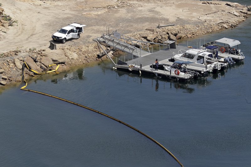 A boom floats across a small bay near the dam wall at Warragamba Dam in Warragamba, Australia, on Wednesday. Although there have been no major impacts on drinking water yet from the intense wildfires, authorities know from experience that the risks will be elevated for years while the damaged catchment areas, including pine and eucalyptus forests, recover. - AP Photo/Rick Rycroft