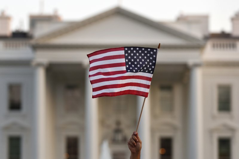  In this Sept. 2017 file photo, a flag is waved outside the White House, in Washington. The Trump administration announced Friday that it was curbing legal immigration from six additional countries that officials said did not meet security screening standards, as part of an election-year push to further restrict immigration. Officials said immigrants from Kyrgyzstan, Myanmar, Eritrea, Nigeria, Sudan and Tanzania will face new restrictions in obtaining certain visas to come to the United States.
(AP Photo/Carolyn Kaster)