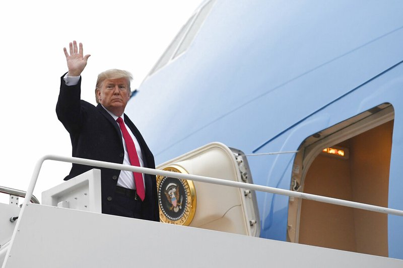 President Donald Trump waves from the top of the steps of Air Force One on Friday at Andrews Air Force Base in Maryland. Hours after the president left with the first lady to spend the weekend at their Mar-a-Lago estate, his administration acknowledged the existence of emails revealing the president's thinking about withholding aid to Ukraine.