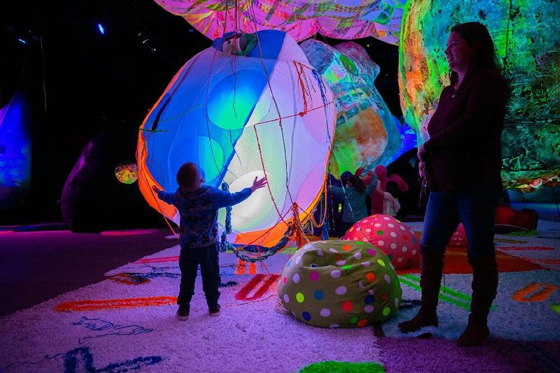 Michael Burke, left, and his mother Dana, interact with performers during opening day of AstroZone, an interactive art exhibit, at the First Financial Music Hall in El Dorado on Saturday, Feb. 1, 2020.
