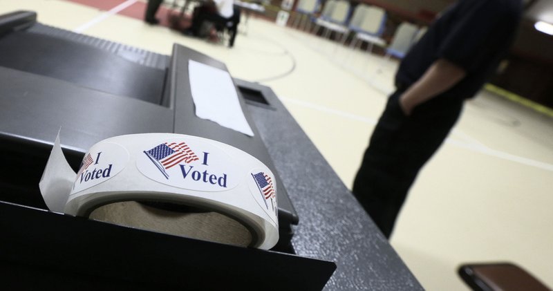 In this 2014 file photo, a roll of "I Voted" stickers sits on a ballot box at a Little Rock, Ark. polling place.  