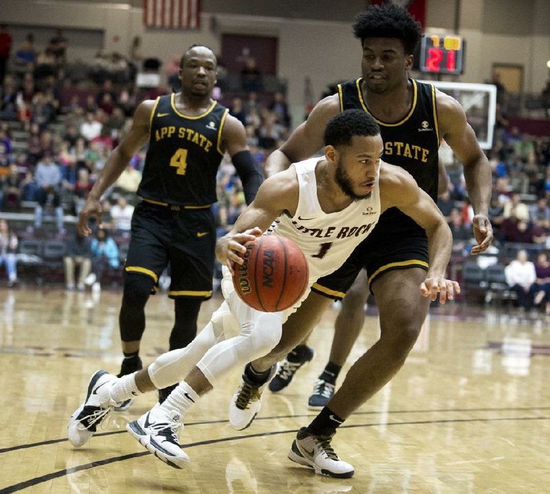 FILE — UALR guard Markquis Nowell (front) drives to the basket against Appalachian State guard Donovan Gregory while teammate O’Showen Williams (4) looks on in this Feb. 2, 2020 file photo.