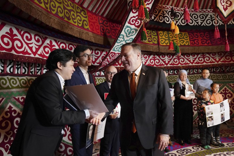 U.S. Secretary of State Mike Pompeo, center, meets with Kazakh citizens who said their family members have been detained in Xinjiang, China, in a yurt at the U.S. Ambassador's residence in Nur-sultan, Kazakhstan, Sunday, Feb. 2, 2020. (Kevin Lamarque/Pool Photo via AP)