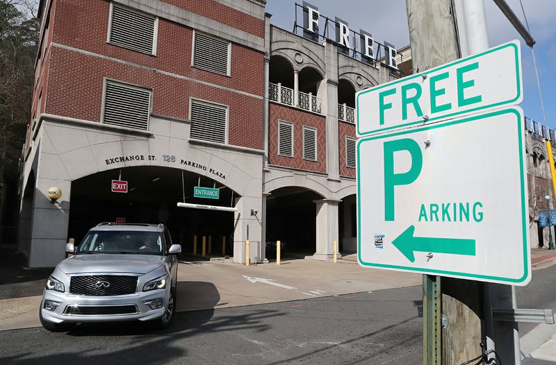 A motorist exits the Exchange Street Parking Plaza Friday. The city is considering converting the multi-level facility's 235 free spaces to paid parking, providing revenue that could finance downtown parking improvements. - Photo by Richard Rasmussen of The Sentinel-Record