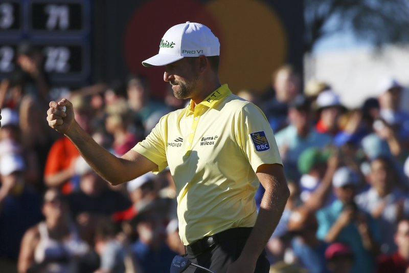 Webb Simpson celebrates making a birdie on the 18th green forcing a playoff during the final round of the Waste Management Phoenix Open Sunday in Scottsdale, Ariz. - Photo Ross D. Franklin of The Associated Press