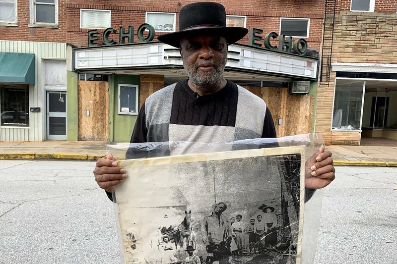 The Rev. David Kennedy stands outside the Echo Theater holding a photo of his great uncle’s lynching, in Laurens, S.C. Kennedy has fought for civil rights in South Carolina for decades.
(AP Photo/Sarah Blake Morgan)