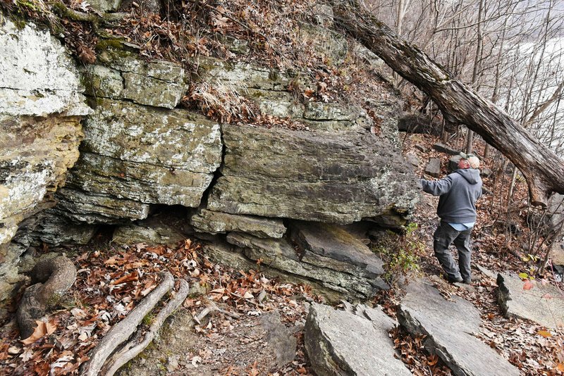 Mike McBride of Winslow looks over formations on Dec. 13, 2019, along the Shepherd Springs Loop trail at Lake Fort Smith State Park. The 5-mile loop takes in part of the Ozark Highlands Trail which runs more than 200 miles across the Arkansas Ozarks. The loop offers a taste of the epic trail. (NWA Democrat-Gazette/Flip Putthoff)