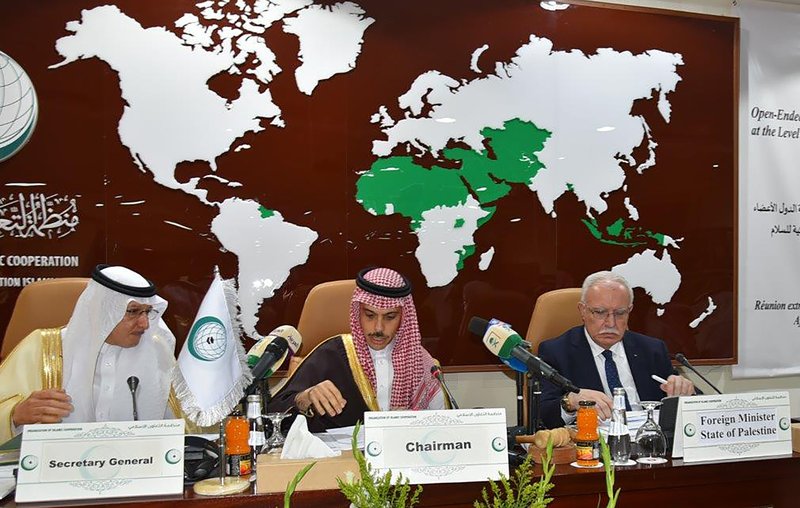 In this photo released by the the Organization of Islamic Cooperation (OIC), from right to left, Palestinian Foreign Minister Riyad al-Maliki, Saudi Foreign Minister Prince Faisal bin Farhan Al Saud, center, and the organization Secretary General, Yousef bin Ahmed Al-Othaimeen, chair an emergency ministerial meeting in Jiddah, Saudi Arabia, Monday, Feb, 3, 2020. Days after Gulf Arab states expressed their support for President Donald Trump's efforts at resolving the Israeli-Palestinian conflict, representatives of Muslim-majority nations gathered in Saudi Arabia and rejected the White House's plan as &#x201c;biased.&quot; (Organization of Islamic Cooperation via AP)