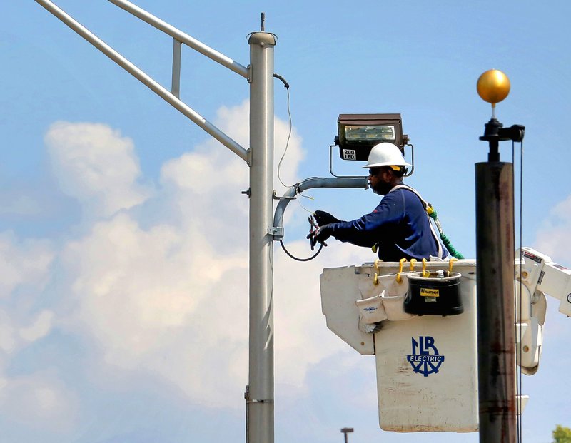 FILE — An employee of the North Little Rock Electric Department is shown in this 2019 file photo.