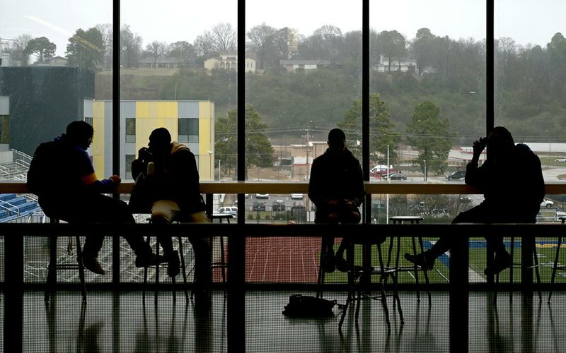 FILE — Kids are shown sitting against the glass in the cafeteria between classes at North Little Rock High School in this 2020 file photo. (Arkansas Democrat-Gazette/Stephen Swofford)