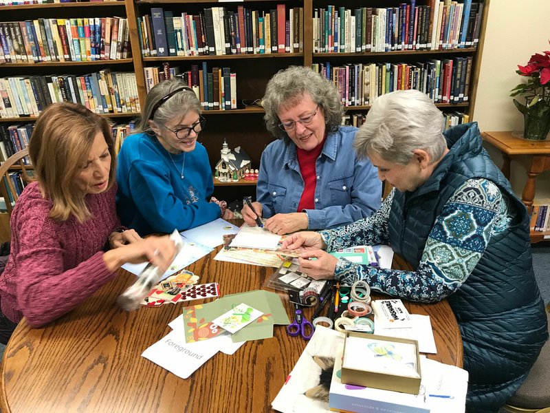 Deena Guptil (from left), Mary Green, Nancy Brennan and Pat Kirby gather to plan for the next meeting of the Northwest Arkansas Letter Writing Society. Only about a year old, the group meets at the Bella Vista Public Library to share correspondence, create mail art and keep alive the personal connection of letters written on paper and mailed. (NWA Democrat-Gazette/Becca Martin-Brown)