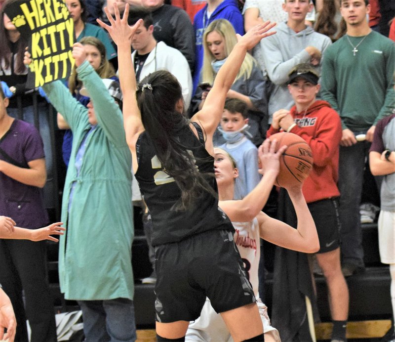 RICK PECK/SPECIAL TO MCDONALD COUNTY PRESS McDonald County's Kristin Penn got guarded up close and personal by Neosho's Olivia Hixson during the Lady Mustangs' 29-24 loss on Jan. 31 at MCHS.