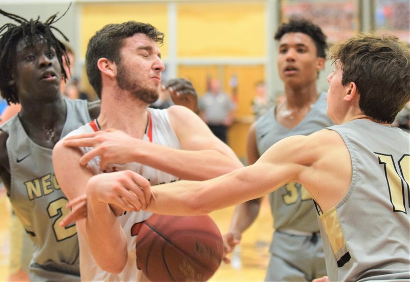 RICK PECK/SPECIAL TO MCDONALD COUNTY PRESS McDonald County's Teddy Reedybacon fights for control of the ball as Neosho's Mason Gammons (10) tries to swat it loose. Neosho's Sam Cook and Landon Austin look on during the Wildcats' 52-40 win on Jan. 31 at MCHS.