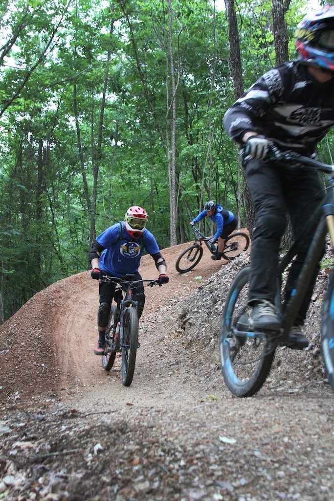 From back, Rodney James, Mark Lovett and Traci Berry, trails coordinator for Visit Hot Springs, ride Ragnarok trail in the Northwoods Trails System in May 2019. - File photo by Jami Smith of The Sentinel-Record